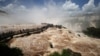 Tourists visit the Iguazu Falls walkway as it reopens to the public after being temporarily closed due to the high water flow from recent heavy rains, in Foz do Iguacu, Parana state Brazil, Dec. 11, 2024.