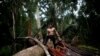 FILE - An indigenous man called Tebu, of the Uru-eu-wau-wau tribe, looks on in an area deforested by invaders in the village of Alto Jaru, at the Uru-eu-wau-wau Indigenous Reserve near Campo Novo de Rondonia, Brazil, Feb. 1, 2019.