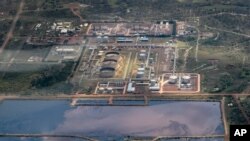 In this photo taken Sept. 27, 2018, a reservoir of polluted water next to an oil field is seen from the air in Palouch, South Sudan.