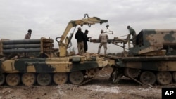 Iraqi army soldiers load rockets into a multibarrel launcher during a fight against Islamic State militants to regain control of Mosul University in the eastern side of Mosul, Iraq, Jan. 13, 2017.