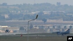 FILE - Turkish Air Force fighter planes maneuver on the runway at the Incirlik Air Base, in Adana, southern Turkey. 