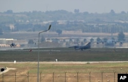 FILE - Turkish Air Force fighter planes maneuver on the runway at the Incirlik Air Base, in Adana, southern Turkey, Aug. 13, 2015.