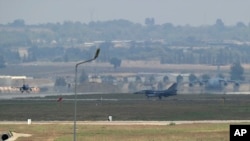FILE - Turkish Air Force fighter planes maneuver on the runway at the Incirlik Air Base, in Adana, southern Turkey, Aug. 13, 2015. 
