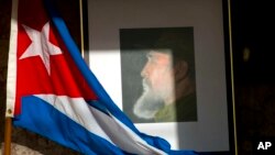 An image of Fidel Castro and a Cuban flag are displayed in honor of the late leader one day after he died, inside the foreign ministry in Havana, Cuba, Nov. 26, 2016. 