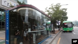 A bus shelter designed to block people with fever amid a spread of the coronavirus, is installed at a bus stop in Seoul, South Korea, Aug. 14, 2020. 