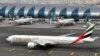 FILE - An Emirates plane taxis to a gate at Dubai International Airport at Dubai International Airport in Dubai, United Arab Emirates. 