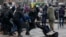 FILE - Belarus police push a woman down while detaining an activist during an opposition rally in Minsk, Belarus, March 25, 2017. 