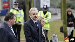 WikiLeaks founder Julian Assange, center, speaks to the media flanked by his lawyers Mark Stephens, left, and Jennifer Robinson, after making an appearance at Belmarsh Magistrates' Court in London, Jan 11, 2011