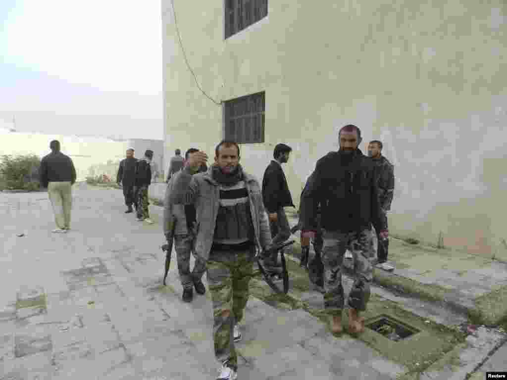 Free Syrian Army fighters are seen at Houla, near Homs, December 3, 2012. 