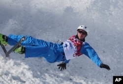 FILE - Anton Kushnir of Belarus crashes during men's freestyle skiing aerials training at the Rosa Khutor Extreme Park, at the 2014 Winter Olympics in Krasnaya Polyana, Russia, Feb. 12, 2014.