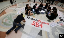 FILE - Students gather in the Texas Capitol to oppose SB4, an anti-sanctuary-cities bill that seeks to jail sheriffs and other officials who refuse to help enforce federal immigration law, in Austin, Texas, April 26, 2017.