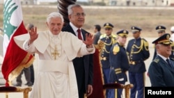 Pope Benedict XVI waves upon his arrival at Beirut international airport as he is welcomed by Lebanon's President Michel Suleiman, September 14, 2012. 