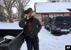 Ryan Bundy talks on the phone at the Malheur National Wildlife Refuge near Burns, Ore., Sunday, Jan. 3, 2016.