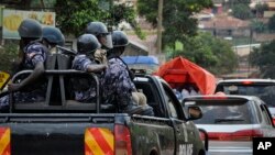 In this file photo, Ugandan riot police patrol on the streets of the Kamwokya neighborhood.