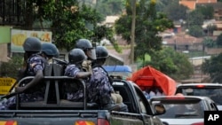 FILE - Ugandan riot police patrol on the streets of the Kamwokya neighborhood.