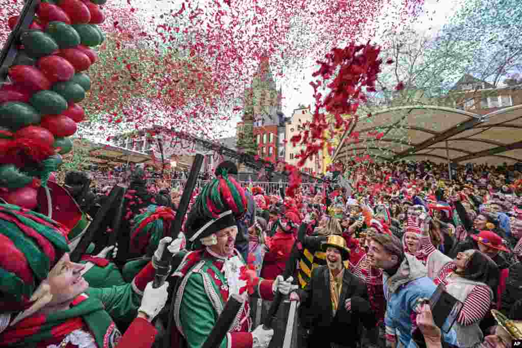 Revelers celebrate the start of the street carnival at the Alter Markt (Old Marketplace) in Cologne, Germany.