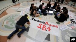 FILE - Students gather in the Texas Capitol to oppose SB4, an anti-sanctuary-cities bill that seeks to jail sheriffs and other officials who refuse to help enforce federal immigration law, in Austin, Texas, April 26, 2017. The legislature passed the bill May 3, 2017.