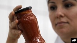 A worker inspects a jar of pasta sauce in one of Paolo Ricciulli's factories - which employs around 220 people at his Althea-Delfino group, Italy's biggest manufacturer of ready-made pasta sauce, with revenues of 62 million euros and two plants in Parma a