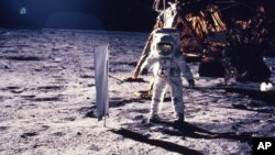 In this July 20, 1969 file photo provided by NASA, astronaut Edwin E. Aldrin Jr. walks on the surface of the moon.