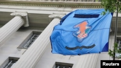 The flag and crest of the United States Department of Justice is seen at their headquarters in Washington, D.C., May 10, 2021. 