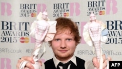 FILE - British singer-songwriter Ed Sheeran poses with his British album of the year award for 'X' and his British male solo artist award at the BRIT Awards 2015 in London on February 25, 2015. AFP PHOTO / LEON NEALRESTRICTED TO EDITORIAL USE, TO ILLUSTRATE THE 