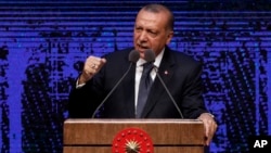 Turkey's President Recep Tayyip Erdogan announces plan of action for the first 100 days of his new presidency, in Ankara, Turkey, Friday, Aug. 3, 2018. 