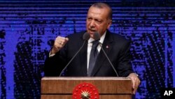 Turkey's President Recep Tayyip Erdogan announces plan of action for the first 100 days of his new presidency, in Ankara, Turkey, Friday, Aug. 3, 2018. 