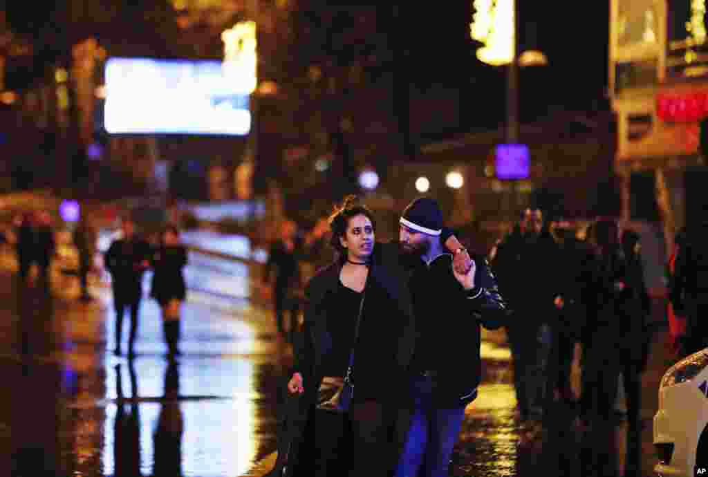 Young people leave the scene of an attack in Istanbul, early Jan. 1, 2017. An assailant opened fire at a nightclub in Istanbul's Ortakoy district during New Year's celebrations, killing dozens of people and wounding dozens more.