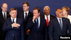 British Prime Minister David Cameron (C) stands amongst other European leaders at the EU Summit in Brussels, Belgium, June 28, 2016. 