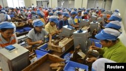 FILE - Workers hand roll Kretek, or clove cigarettes, widely popular in the country at a factory in Kudus, Central Java province, Indonesia, March 17, 2016 in this photo taken by Antara Foto. 