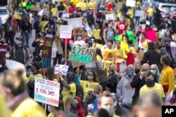 In this March 13, 2021, file photo, parents, students, teachers and supporters march during a rally for San Francisco public schools to reopen during the coronavirus pandemic in San Francisco. (AP Photo/Jeff Chiu, File)