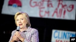 A Pokemon poster is visible behind Democratic presidential candidate Hillary Clinton as she speaks to volunteers at a Democratic party organizing event at the Neighborhood Theater in Charlotte, N.C., July 25, 2016. 