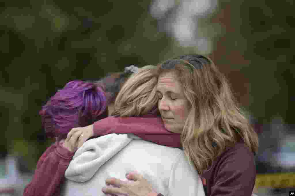 Cody Murphy, Sabrina Weihrauch, and Amanda Godley hug after an active shooter situation at Tree of Life Synagogue on Saturday, Oct. 27, 2018. (Andrew Stein/Pittsburgh Post-Gazette via AP)