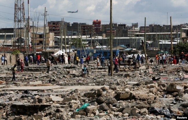 Residents gather during a clash over the demolition of homes at the Mukuru Kwa Njenga informal settlements in Nairobi, Dec. 27, 2021.