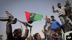 Libyan rebels jubilate after taking the city of Ajdabiya, south of Benghazi, eastern Libya, Saturday, March 26, 2011. Libyan rebels regained control of the eastern gateway city of Ajdabiya on Saturday after international airstrikes on Moammar Gadhafi's f
