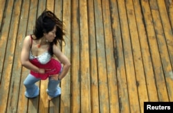 FILE - Chinese internet star Furong Jiejie, aka Sister Furong, dances on a roof in Beijing, Aug. 10, 2005.