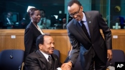 Rwanda President Paul Kagame, right, greets Cameroon President Paul Biya as he arrives for a meeting on Central African Republic, Brussels, April 2, 2014.