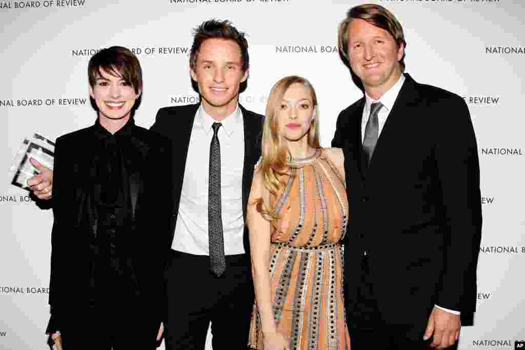 This January 8, 2013 Starpix photo shows, from left, Les Miserables' Anne Hathaway, Eddie Redmayne, and Amanda Seyfried with director Tom Hooper at the National Board of Review awards gala in New York.