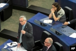 European Commission President Jean-Claude Juncker, left, gestures at the European Parliament in Strasbourg, eastern France, July 8, 2015.
