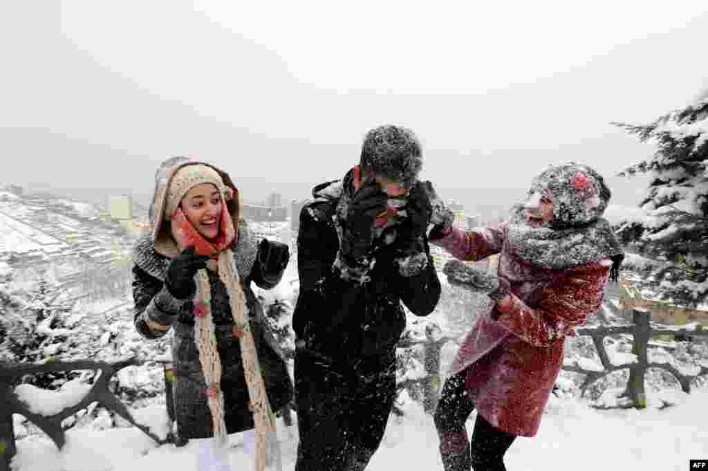 Iranian youths play with snow at Tochal mountain, just north of Tehran. The heaviest snowstorm in five decades has blanketed provinces in northern Iran, cutting power supplies and trapping villagers, Iranian media reported.
