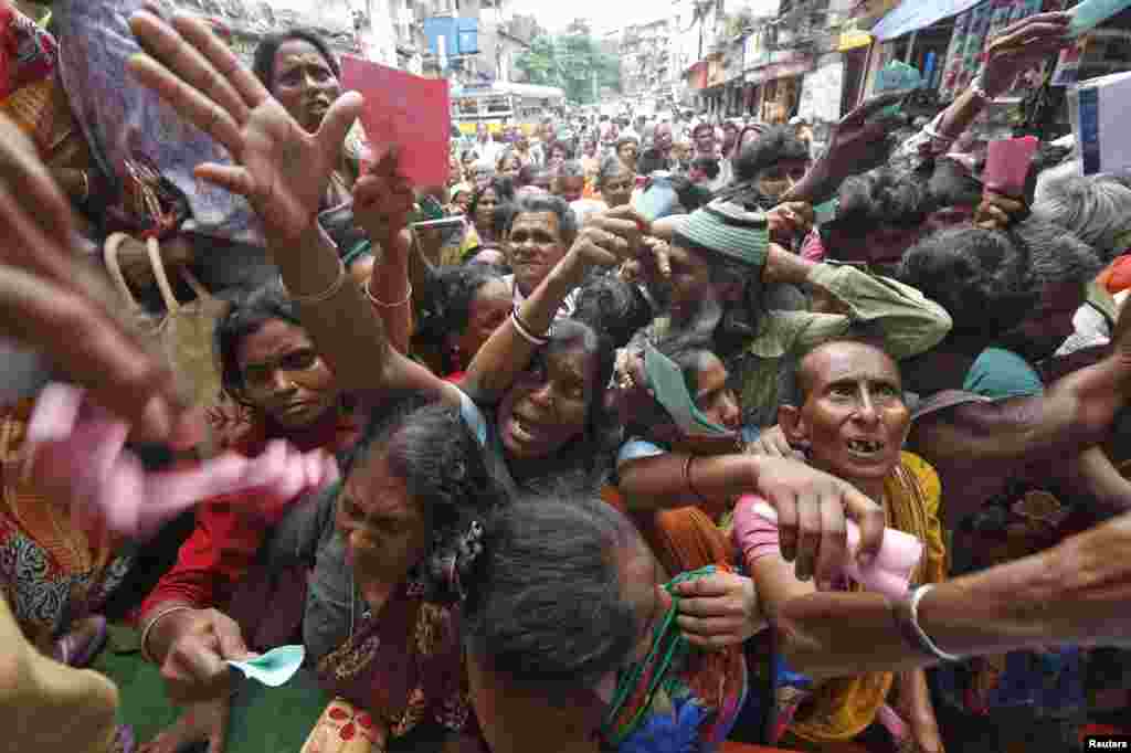 People collect free clothes outside a mosque ahead of the Eid al-Fitr festival, which marks the end of the holy Muslim fasting month of Ramadan, in Kolkata, India.