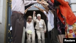 Stacy Wood, left, and her wife, Michele Barr, leave San Francisco City Hall after getting married, June 26, 2015. 