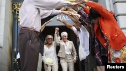 Stacy Wood, left, and her wife, Michele Barr, leave San Francisco City Hall after getting married, June 26, 2015.