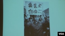 舒陽展示1979年10月北京藝術家參與遊行時高舉「要藝術要自由」的標語的照片