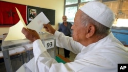 A Moroccan man casts his ballot in a polling station for municipal elections in Casablanca, Morocco, Sept. 4, 2015. 