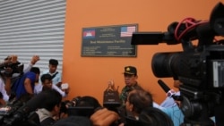 Chhum Socheat, spokesperson for Cambodia’s defense ministry, shows a group of invited journalists the US-funded Boat Maintenance Facility building during a rare media tour at Ream Naval Base in Preah Sihanouk province, Friday, July 26, 2019. (Sophat Soeung/VOA Khmer)