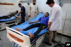 Injured protesters receive treatment at a hospital in Basra, Iraq, Sept. 9, 2018.