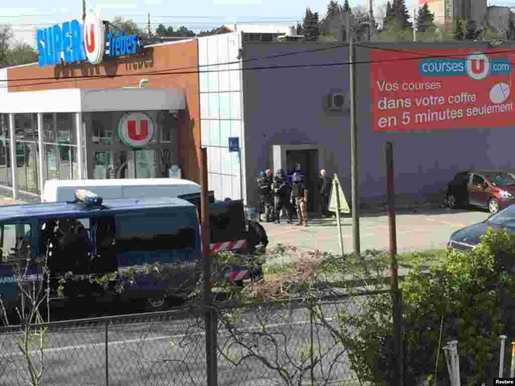 Police are seen at the scene of a hostage situation in a supermarket in Trebes, Aude, France, in this picture obtained from a social media video.