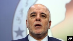 FILE - Shiite lawmaker and Deputy Parliament Speaker Haider al-Abadi speaks to the media after an Iraqi parliament session in Baghdad.