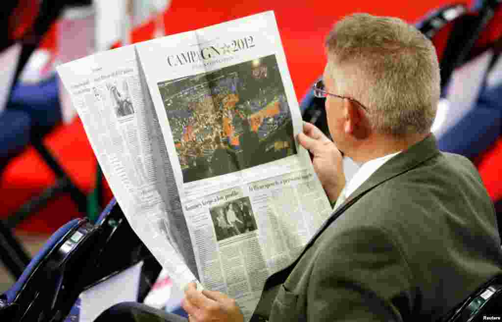 A man reads The Washington Post before the start of the second session of the RNC.